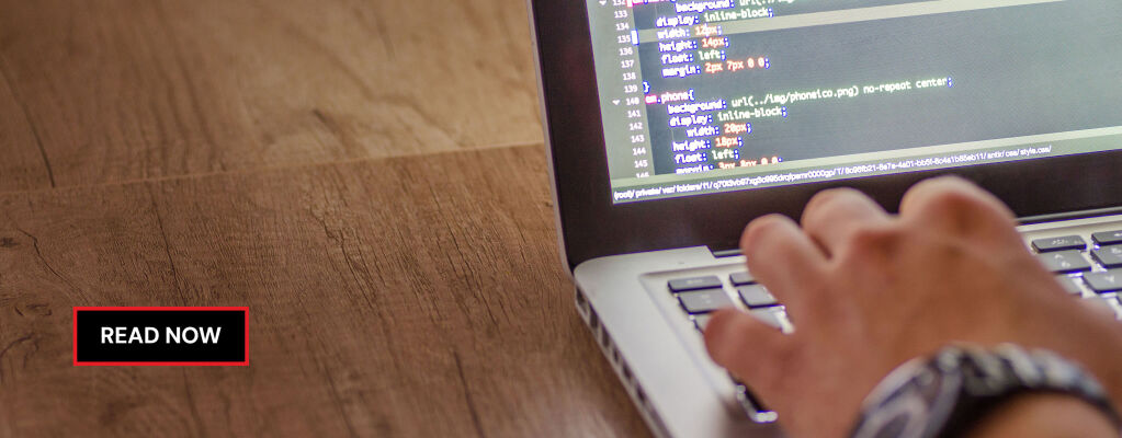 Hand typing on a laptop keyboard with colorful programming code displayed on the screen, set on a wooden desk. 3D rendering, design studio, 3D product, animation, character design, 2D animation, video production services, book trailer services, digital marketing services, motion design, motion graphics. RDV Media – Multimedia production company. Serving brands globally. New York, Los Angeles, California, Atlanta, USA, Dublin, Ireland, EU, London, England, UK, Doha, Qatar, UAE, Abu Dhabi, Ajman, Dubai, Fujairah, Ras Al Khaimah, Sharjah, and Umm Al Quwain.