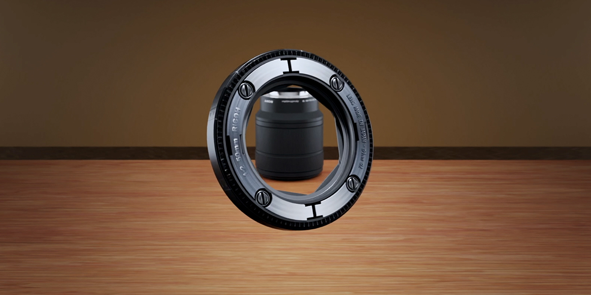A photorealistic 3D modeled camera lens is presented on a wooden table. 3D rendering, design studio, 3D product, animation, character design, 2D animation, video production services, book trailer services, digital marketing services, motion design, motion graphics. RDV Media – Multimedia production company. Serving brands globally. New York, Los Angeles, California, Atlanta, USA, Dublin, Ireland, EU, London, England, UK, Doha, Qatar, UAE, Abu Dhabi, Ajman, Dubai, Fujairah, Ras Al Khaimah, Sharjah, and Umm Al Quwain.
