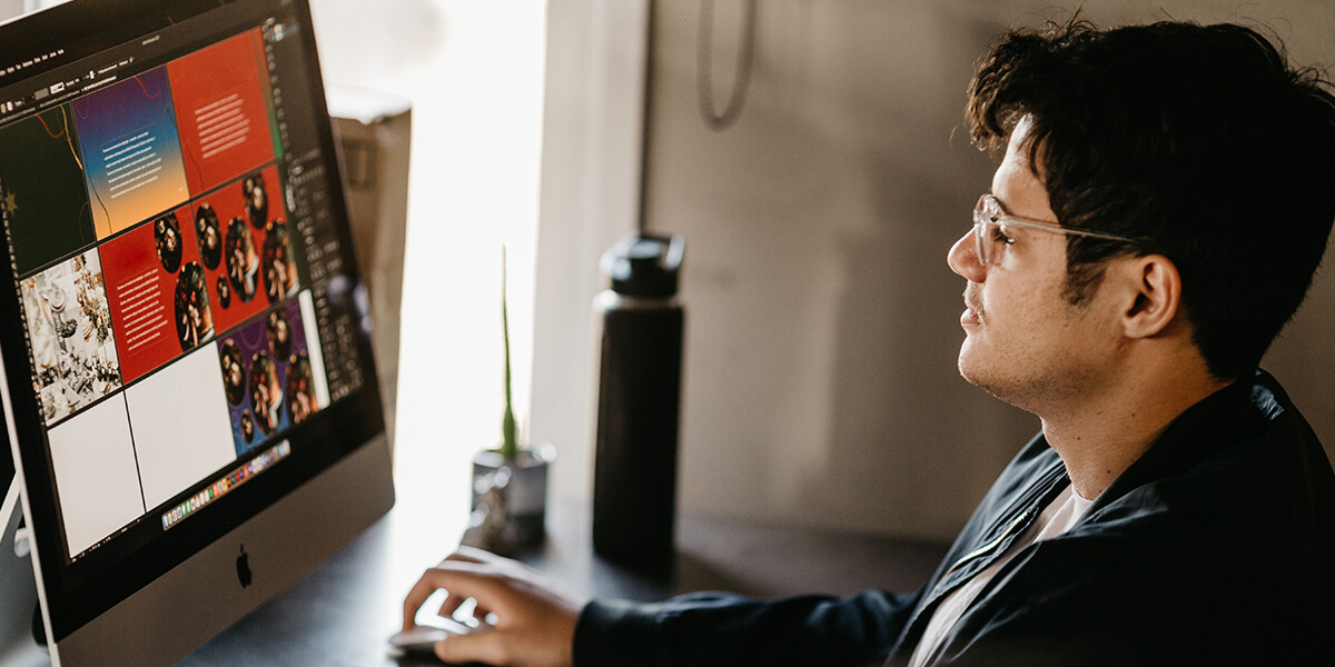 Person sitting at a desk, working on a computer, with a water bottle and a small plant nearby, in a softly lit indoor setting. 3D rendering, design studio, 3D product, animation, character design, 2D animation, video production services, book trailer services, digital marketing services, motion design, motion graphics. RDV Media – Multimedia production company. Serving brands globally. New York, Los Angeles, California, Atlanta, USA, Dublin, Ireland, EU, London, England, UK, Doha, Qatar, UAE, Abu Dhabi, Ajman, Dubai, Fujairah, Ras Al Khaimah, Sharjah, and Umm Al Quwain.