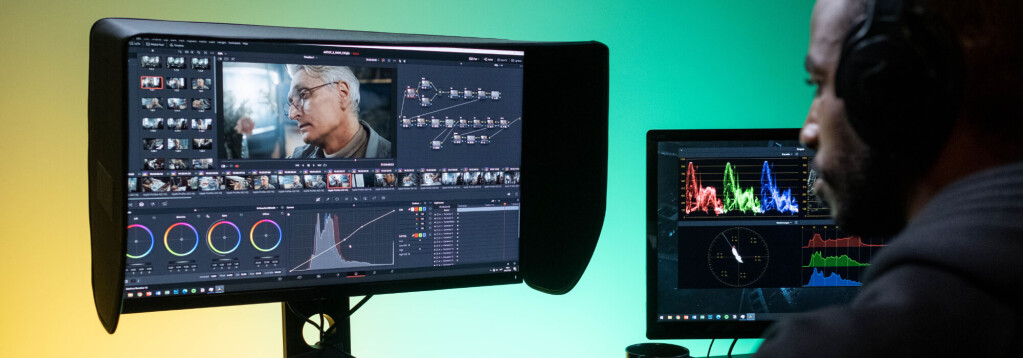 Two computer screens displaying professional video editing software featuring color grading tools and a video clip with a person’s face, set against a green background. 3D rendering, design studio, 3D product, animation, character design, 2D animation, video production services, book trailer services, digital marketing services, motion design, motion graphics. RDV Media – Multimedia production company. Serving brands globally. New York, Los Angeles, California, Atlanta, USA, Dublin, Ireland, EU, London, England, UK, Doha, Qatar, UAE, Abu Dhabi, Ajman, Dubai, Fujairah, Ras Al Khaimah, Sharjah, and Umm Al Quwain.
